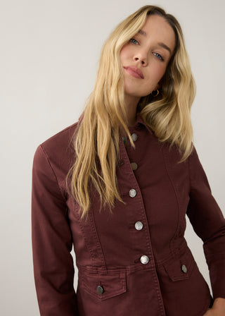 Woman wearing a merlot colored button up jacket