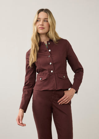 Woman wearing a button up jacket and similar colored pants
