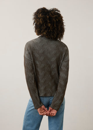 Back of woman in a geometric print sweater