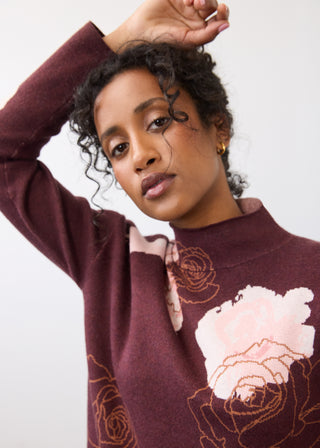 Woman modeling a floral print sweater