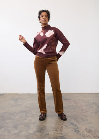 Woman modeling  a sweater and camel colored pants