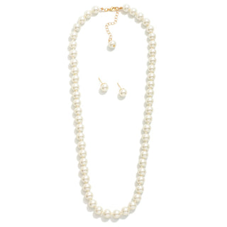 A pearl necklace and matching stud earrings with gold-tone hardware, displayed on a clean white background.