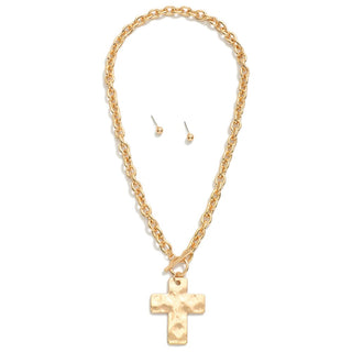 Gold chain necklace with cross pendant and matching earrings on a white background