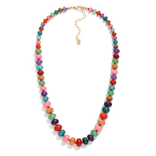 A colorful beaded necklace with round, faceted beads in multiple vibrant colors including pink, green, red, orange, purple, and blue, connected by a gold-tone chain and clasp, shown on a plain white background.