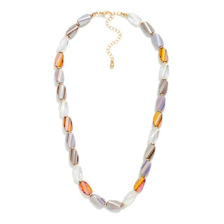 A beaded necklace featuring elongated oval beads in white, lavender, brown, and amber-orange, separated by gold-toned spacers, with a gold chain extender clasp at the top, shown on a plain white background.
