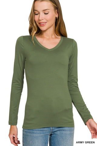 A woman wearing a long-sleeve V-neck knit top in army green, paired with blue jeans, against a plain white background.