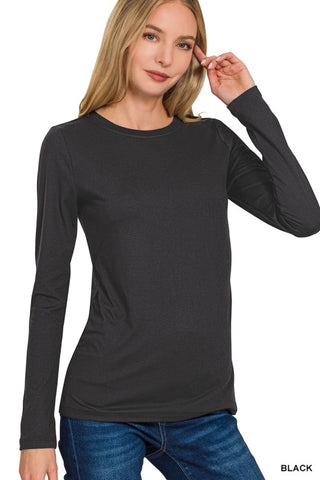 A woman wearing a dark charcoal gray long-sleeve crewneck top and blue jeans, shown against a plain white background with a 'BLACK' text label in the bottom right corner.