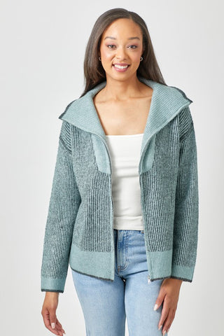 Woman wearing a green textured jacket on a light gray background