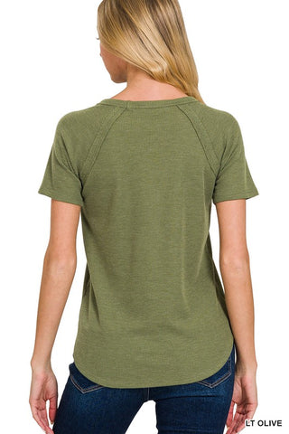 Woman wearing a green t-shirt with short sleeves on a white background