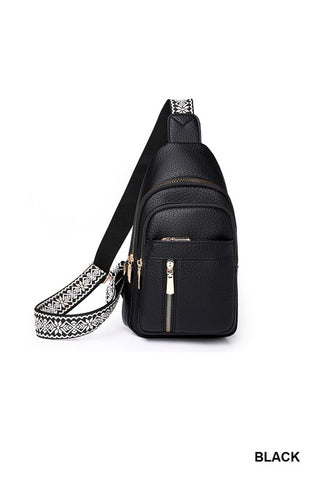 Black sling bag with decorative strap on a white background