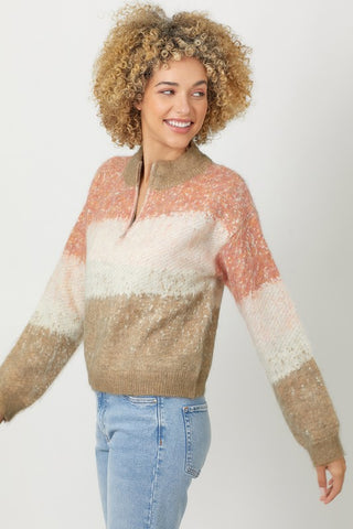 Woman wearing a colorful sweater with a plain background