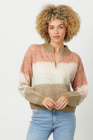 Woman wearing a colorful sweater with a plain background