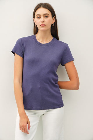 Woman wearing an indigo t-shirt against a white background