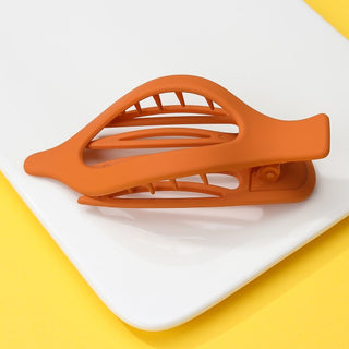 Orange hair clip on a white background with a yellow border
