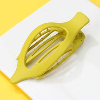Yellow hair clip on a white and yellow striped background