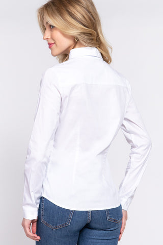 Woman wearing a white shirt and blue jeans on a plain background