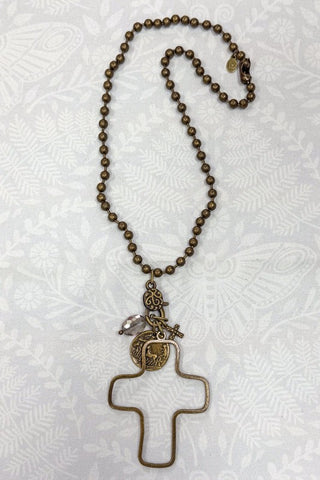 Necklace with a cross pendant on a textured white background