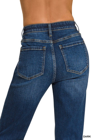 Rear view of a person wearing dark blue denim jeans against a plain white background, with the word 'DARK' in the bottom right corner.