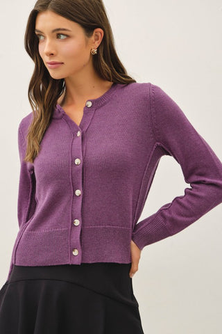Woman wearing a purple button up sweater