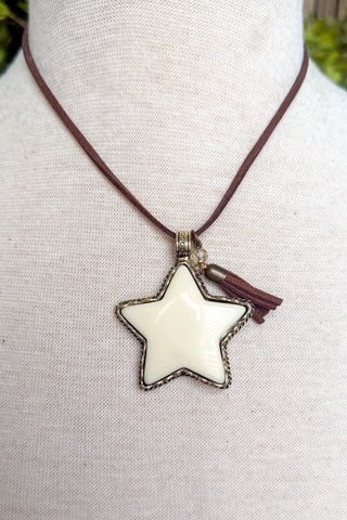 Brown necklace with white star pendant and brown tassel