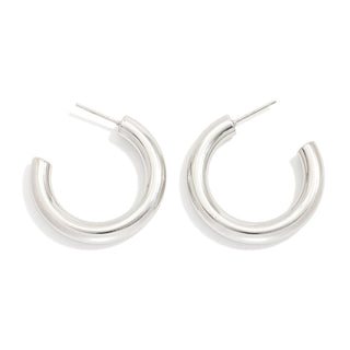 Pair of silver hoop earrings on a white background