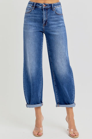 Blue jeans with rolled cuffs on a white background