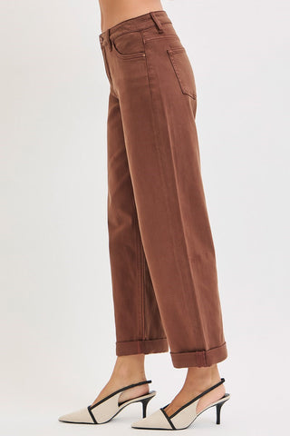 Side of woman wearing heels and brown pants