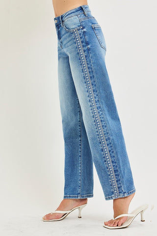 Blue jeans worn by a person on a white background