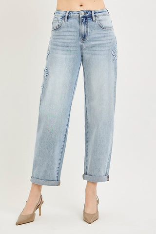 Light blue jeans worn by a person on a plain background