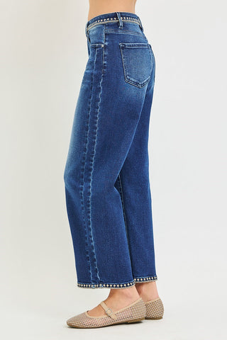 Side of woman wearing jeans with geometric stitching