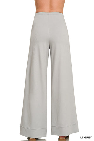 Back of a woman wearing grey slacks
