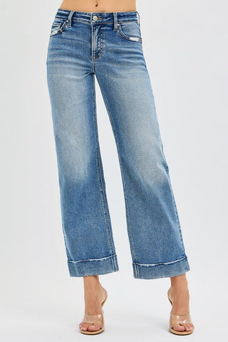 Blue jeans worn by a person on a white background