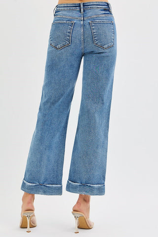 Blue jeans worn by a person on a light gray background
