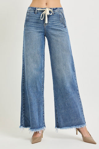 Blue jeans with a tie waist on a white background