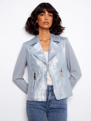 Woman wearing a light blue metallic jacket on a white background