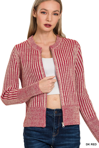 Woman wearing a red striped cardigan over a white shirt with jeans