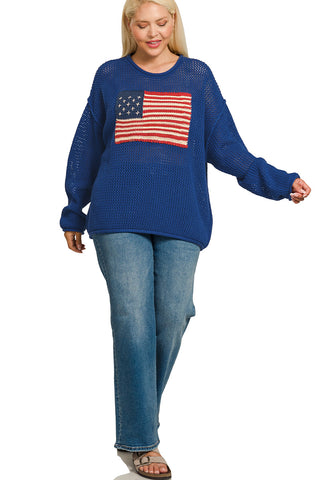 Woman wearing a blue sweater with an American flag design on a white background