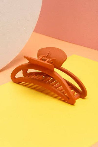 Brown hair clip on a colorful background