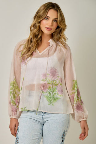 Woman wearing a floral blouse with a plain background